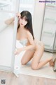 A woman in lingerie posing in front of a mirror.